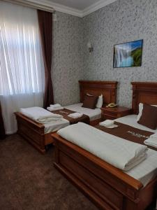 Postel nebo postele na pokoji v ubytování Maximum Hotel