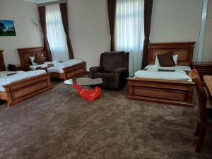 Postel nebo postele na pokoji v ubytování Maximum Hotel