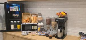 a counter with a coffee maker and a microwave at Hipotel Paris Voltaire Bastille in Paris