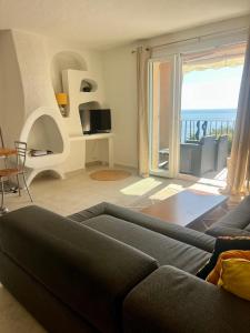 a living room with a couch and a view of the ocean at Residence port la galere in Théoule-sur-Mer