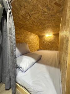 a bed in a small room with a stone wall at 蘭嶼Hi海背包客棧 in Lanyu +11 photos