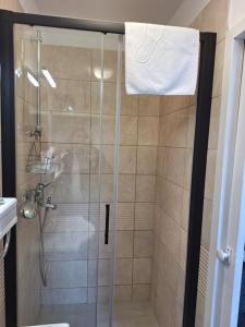 a bathroom with a shower with a glass door at Dolce Vita Old Town Studio in Dubrovnik