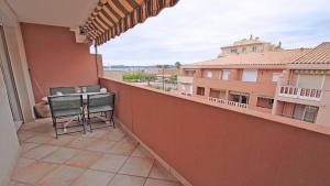 a balcony with a table and chairs on a balcony at Regina - Victoria in Sainte-Maxime