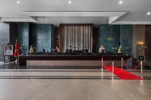 a lobby with a red carpet in front of a desk at Hotel Riu Palace Tikida Agadir - All Inclusive in Agadir +37 photos