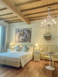 a bedroom with a bed and a chandelier and a table at Florence Art Apartments in Florence