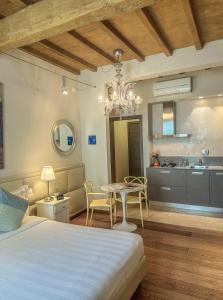 a bedroom with a bed and a table and a kitchen at Florence Art Apartments in Florence +81 photos