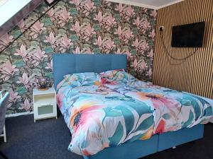 Postel nebo postele na pokoji v ubytování Hotel Dichtbijzee