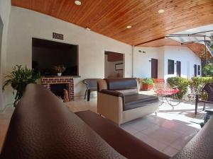 a living room with a couch and a fireplace at Casa Montpellier in Honda +28 photos
