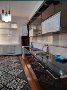 a kitchen with a sink and a counter top at Guesthouse in Samarkand
