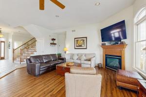 a living room with a couch and a fireplace at Heron's Retreat in Ocean City