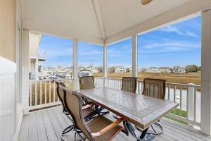 a screened porch with a table and chairs on it at Heron's Retreat in Ocean City
