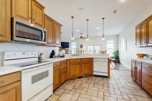 a kitchen with white appliances and wooden cabinets at Heron's Retreat in Ocean City