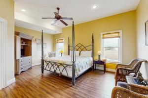 a bedroom with a bed and a ceiling fan at Heron's Retreat in Ocean City +24 photos