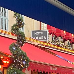 a hotel salaria sign on a building with christmas trees at Hotel Solara in Nice