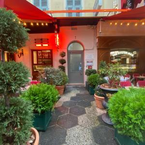 a restaurant with potted plants in front of a door at Hotel Solara in Nice