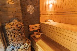 a room with a sauna with a stack of logs at Privát Prima in Liptovský Ján
