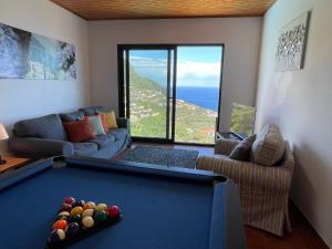 a living room with a pool table with a view at Casa Vista do Ledo in Arco da Calheta