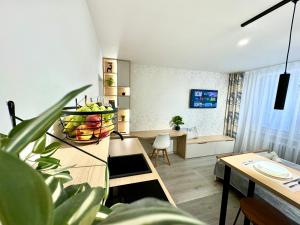 a living room with a table with a bowl of fruit at Stylish City Studio - Bezplatné parkovanie in Žilina