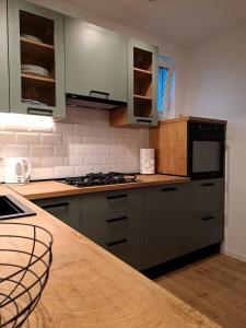 a kitchen with gray cabinets and a counter top at Dedin dvorac in Valpovo