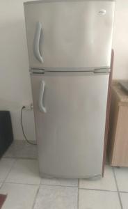 a white refrigerator with two handles in a kitchen at Playa sol y arena in Puntarenas