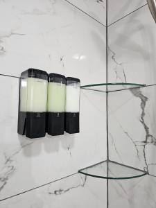 a set of three candle holders on a marble wall at Charming Forest Apartment in Lumberton +53 photos