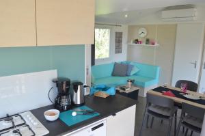 a kitchen with a blue couch in a room at MainMoment in Kulmbach