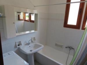 a white bathroom with a sink and a bath tub at VILLA DOLPHIN VOTSI in Votsi +28 photos