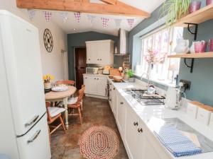 a kitchen with a counter top and a table at Chapel Cottage in Ebberston
