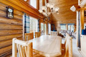 a dining room with a wooden table and chairs at Cascade Lakeview Log Cabin in Cascade