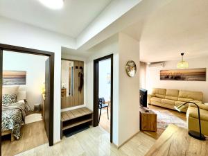 a room with a bed and a living room at Apartments Terra Solaris in Medulin