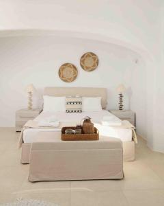 a bedroom with a bed with a basket on it at The Mykonian Escape in Mýkonos City
