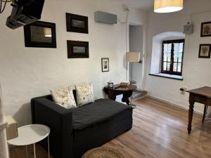 a living room with a couch and a table at Casa dei Nonni in Baveno