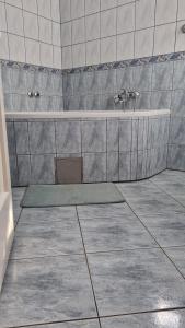 a bathroom with a bath tub and a sink at Prenoćište Duran in Županja
