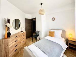 a bedroom with a bed and a dresser and a mirror at Apartments Terra Solaris in Medulin