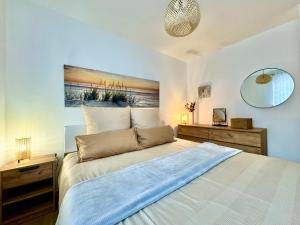 a bedroom with a large bed with a blue blanket at Apartments Terra Solaris in Medulin