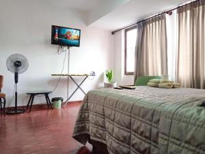 Кровать или кровати в номере Estudio Moderno Cerca de la PLaza