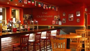 a bar in a restaurant with chairs and a table at Great Western Hotel Aberdeen in Aberdeen
