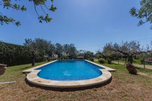 a swimming pool in the yard of a house at Innouthome Casa Rural_el Nostre Cantir in L'Ametlla de Mar