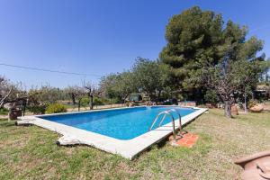 a swimming pool in a yard with trees at Innouthome Casa Rural_el Nostre Cantir in L'Ametlla de Mar