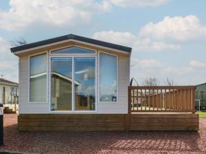 a tiny house with a large window and a porch at New Horizon in Carlisle