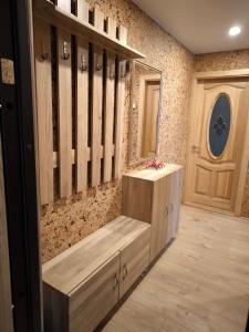 a dressing room with a wooden bench and a door at Debreceno apartamentai in Klaipėda +15 photos