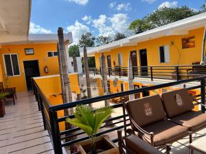 a balcony of a hotel with chairs and tables at Hotel Iker in Tulum