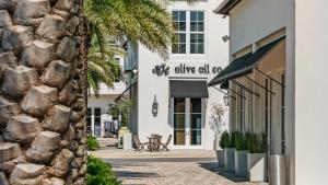 a facade of a white building with a stone wall at Seacrest Townhomes 7 - Sol and Sea in Seacrest +25 photos