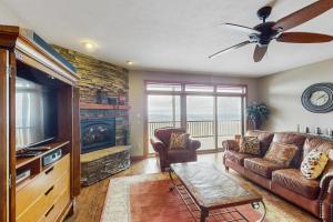 a living room with a couch and a tv at Reserve 19-D in Sugar Mountain