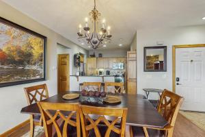 a dining room and kitchen with a table and chairs at Reserve 19-D in Sugar Mountain
