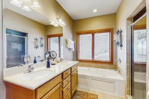 a bathroom with a sink and a tub and a shower at Reserve 19-D in Sugar Mountain +21 photos