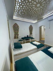 Postel nebo postele na pokoji v ubytování Olimxon Guest House