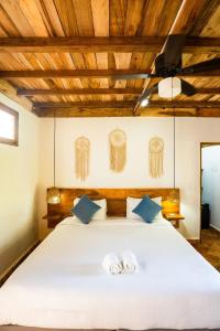 a bedroom with a bed with two towels on it at Casa Origen Boutique en San Bernardo del Viento in San Bernardo del Viento +20 photos