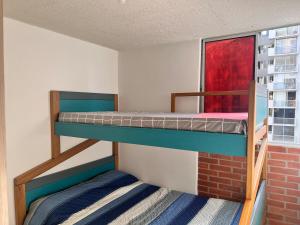two bunk beds in a room with a window at Max House 503 in Soledad