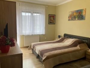 A bed or beds in a room at Jászay vendégház Parádsasvár